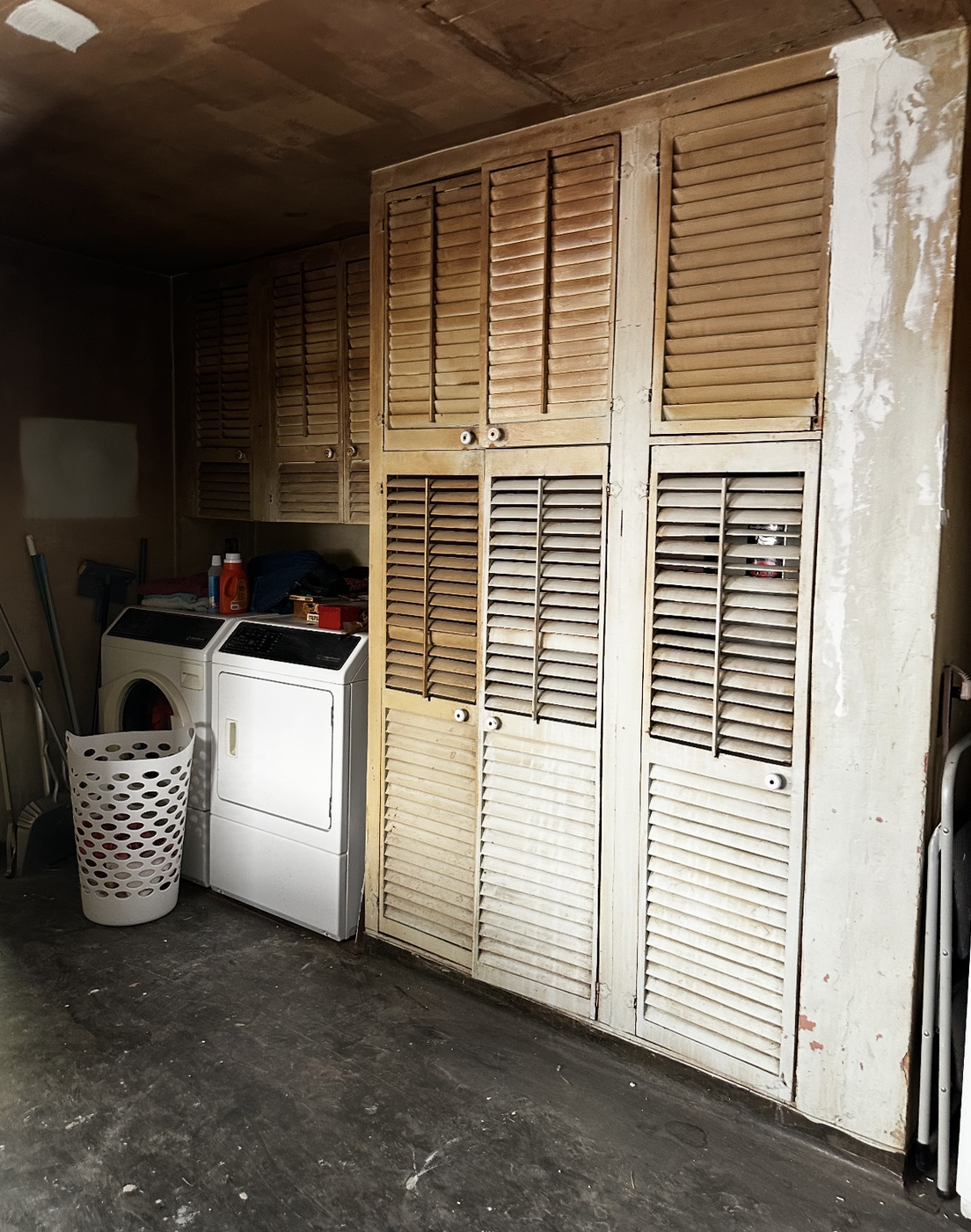Current laundry area with original louvered cabinets and washer/dryer as it looks right now