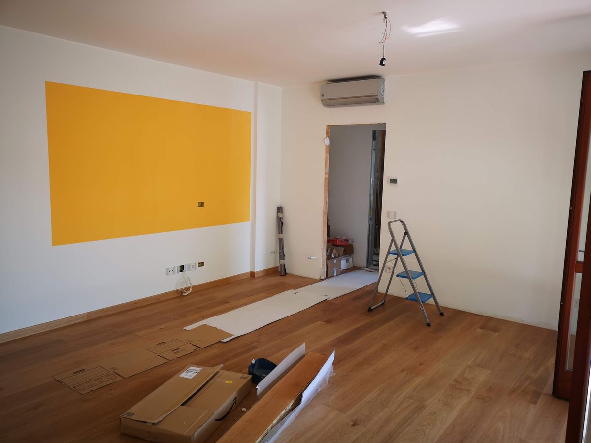 Hardwood floor planks being installed in a home