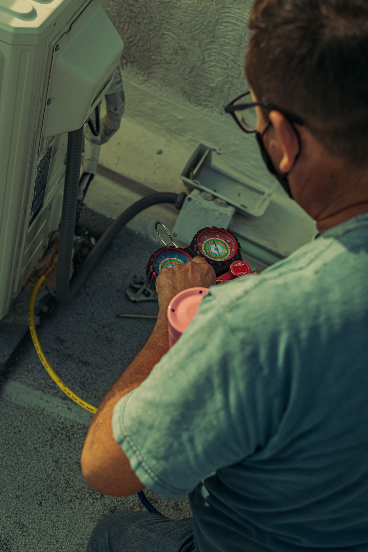 HVAC technician servicing a heating and cooling unit