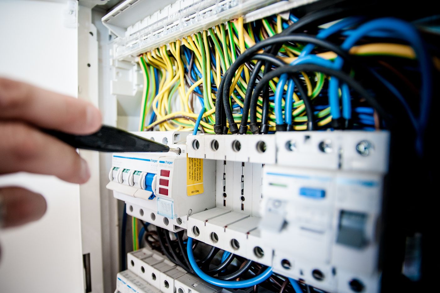 Electrician working on a residential electrical panel and wiring