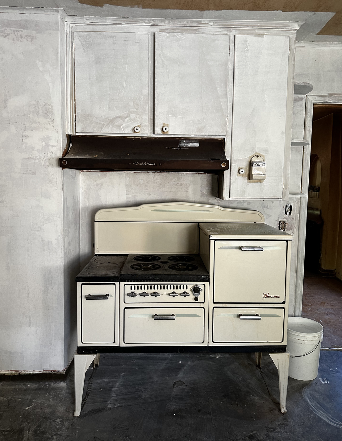 Vintage Wedgewood stove and original painted cabinets in the kitchen as it looks right now