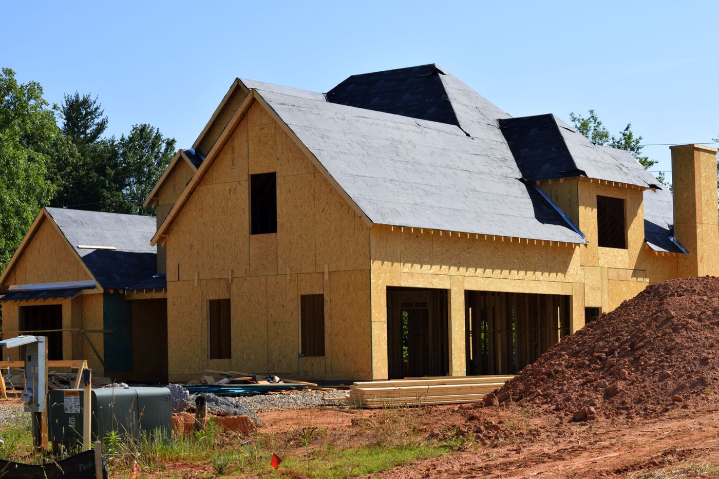 New roof decking and framing going up on a home under construction