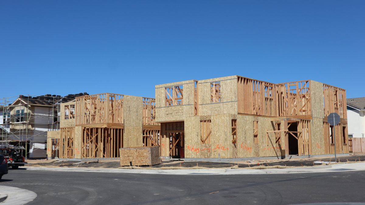 Framed house under construction on a clear day
